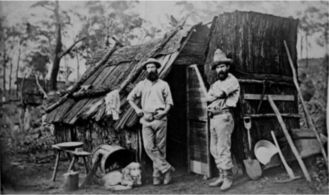 Gold miners outside a bark hut, Queensland, ca. 1870